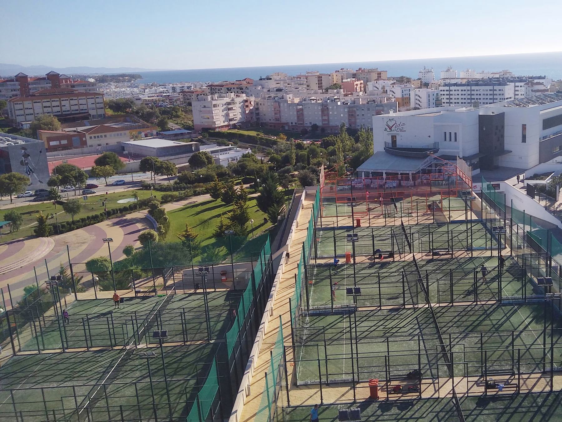 The outdoor padel courts at Las Mesas, Estepona, with the sea in the background