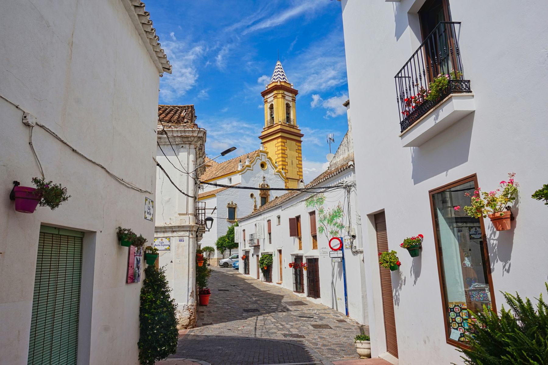 Church tower and white street in Estepona
