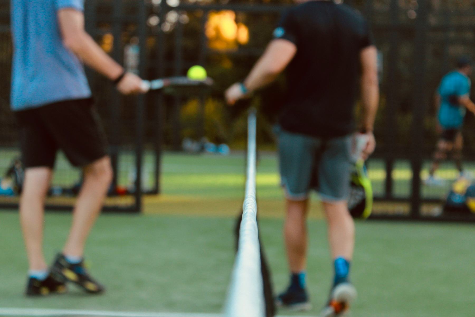 Players during a padel match on an outdoor court